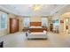 Large main bedroom features tray ceilings, plantation shutters, and neutral carpet at 1686 Shadowmoss Cir, Lake Mary, FL 32746