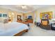 Bright main bedroom with a ceiling fan, dresser, sitting area, and tray ceiling at 1686 Shadowmoss Cir, Lake Mary, FL 32746