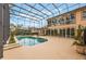 Backyard screened pool with patio, plants, and a view of the home at 1686 Shadowmoss Cir, Lake Mary, FL 32746