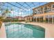 Enclosed screened in pool with clear blue water, spa, and multiple lounge chairs at 1686 Shadowmoss Cir, Lake Mary, FL 32746