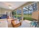 Cozy sun room with tile floors, a hammock and beautiful view of the screened pool and backyard at 1686 Shadowmoss Cir, Lake Mary, FL 32746