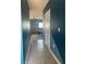 Hallway with tile flooring leading into the living area featuring neutral paint at 1707 Ambar Ct, Winter Haven, FL 33881