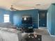 Cozy living room with plush seating, ceiling fan, and a modern entertainment setup at 1707 Ambar Ct, Winter Haven, FL 33881