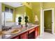 Bathroom featuring a double vanity, granite countertop, and framed mirror at 2020 Windcrest Lake Cir, Orlando, FL 32824