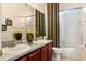 Bathroom boasts double sinks, granite countertops, and framed mirrors at 2020 Windcrest Lake Cir, Orlando, FL 32824