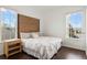 Bedroom with hardwood floors, side table, and a large window at 2020 Windcrest Lake Cir, Orlando, FL 32824