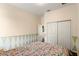 This bedroom features wood floors, neutral paint, and an open closet at 2020 Windcrest Lake Cir, Orlando, FL 32824