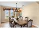 Formal dining room featuring a wooden table with seating for eight and decorative light fixture at 2020 Windcrest Lake Cir, Orlando, FL 32824