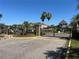 Gated community entrance with brick pillars, mature trees, and well-manicured landscaping at 2020 Windcrest Lake Cir, Orlando, FL 32824