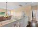 Open landing with hardwood floors, white railing, and a view of a bedroom and bathroom at 2020 Windcrest Lake Cir, Orlando, FL 32824