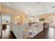 Bright landing with hardwood floors, white railings, and a view of a bedroom and living area at 2020 Windcrest Lake Cir, Orlando, FL 32824