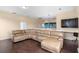 Upstairs living area with hardwood floors, a large sectional sofa, and a built-in bar area at 2020 Windcrest Lake Cir, Orlando, FL 32824