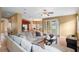 Spacious living room with tile flooring, gray sectional sofa, and french doors to the outside at 2020 Windcrest Lake Cir, Orlando, FL 32824