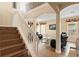Bright living room with hardwood floors and staircase, bathed in natural light from large windows at 2020 Windcrest Lake Cir, Orlando, FL 32824