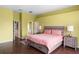 Spacious main bedroom with hardwood floors, king-size bed, and an ensuite bathroom at 2020 Windcrest Lake Cir, Orlando, FL 32824
