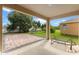 This covered patio features a paved section and a metal lounger with a view of the lawn at 2020 Windcrest Lake Cir, Orlando, FL 32824