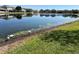 A serene pond reflecting surrounding homes, complemented by the greenery and white birds on the shore at 2020 Windcrest Lake Cir, Orlando, FL 32824