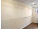 A walk-in closet with white wire shelving and hardwood floors at 2020 Windcrest Lake Cir, Orlando, FL 32824