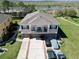 Aerial shot of a three-story townhome with a balcony, garages, and close proximity to the highway at 2120 Betsy Ross Ln, St Cloud, FL 34769