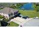 Aerial view of a townhome with a private driveway, garage, and proximity to a scenic lake at 2120 Betsy Ross Ln, St Cloud, FL 34769