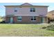 A spacious backyard with a green lawn and patio, perfect for outdoor entertaining and relaxation at 2120 Betsy Ross Ln, St Cloud, FL 34769