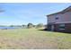 Expansive backyard featuring lush green grass, a serene lake view, and a well-maintained lawn at 2120 Betsy Ross Ln, St Cloud, FL 34769
