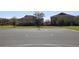 Outdoor basketball court between buildings, featuring a pristine playing surface and hoop at 2120 Betsy Ross Ln, St Cloud, FL 34769