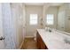 Bathroom featuring a double vanity with a large mirror, natural lighting, and a shower/tub combo at 2120 Betsy Ross Ln, St Cloud, FL 34769