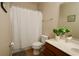 Cozy bathroom featuring a shower-tub combo, plant decor, and a clean, neutral color palette at 2120 Betsy Ross Ln, St Cloud, FL 34769