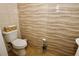 A tiled bathroom with a toilet, decorative wall tiles, and a stylish toilet paper holder enhances the overall design at 2120 Betsy Ross Ln, St Cloud, FL 34769