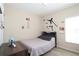 Cozy bedroom with wood floors, decorated with sport-themed decals, and a comfortable bed with grey linens at 2120 Betsy Ross Ln, St Cloud, FL 34769