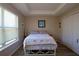 Cozy bedroom featuring a tray ceiling, neutral walls, and natural light from a bright window at 2120 Betsy Ross Ln, St Cloud, FL 34769