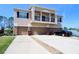 Three-story townhome exterior, showcasing garages, driveways, and a charming second-story balcony at 2120 Betsy Ross Ln, St Cloud, FL 34769