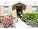 Charming townhouse front door with a lovely landscaped entrance, plants, and welcoming decor at 2120 Betsy Ross Ln, St Cloud, FL 34769