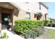 Inviting townhome entrance with door decor and manicured bushes at 2120 Betsy Ross Ln, St Cloud, FL 34769