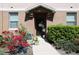 Welcoming townhouse front door with beautiful plants, decor, and a landscaped entrance area at 2120 Betsy Ross Ln, St Cloud, FL 34769