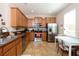 Well-equipped kitchen featuring wooden cabinetry, stainless steel appliances, and a cozy dining area at 2120 Betsy Ross Ln, St Cloud, FL 34769