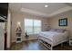 Bedroom with modern tray ceilings, wood flooring, and a large sunny window for natural light at 2120 Betsy Ross Ln, St Cloud, FL 34769