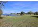 Picturesque pond view showcases a tranquil grassy landscape and a serene body of water at 2120 Betsy Ross Ln, St Cloud, FL 34769