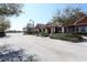 Serene street view showcases well-kept homes with vibrant landscaping and a tranquil pond at 2120 Betsy Ross Ln, St Cloud, FL 34769