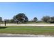 Outdoor volleyball court with net, set against a backdrop of lush green grass and mature trees at 2120 Betsy Ross Ln, St Cloud, FL 34769