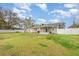 Spacious backyard featuring a well-maintained lawn and a white vinyl fence, perfect for outdoor activities at 2237 Avenue B Nw, Winter Haven, FL 33880