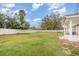 Large backyard space enclosed by a pristine white vinyl fence, providing privacy and a secure area at 2237 Avenue B Nw, Winter Haven, FL 33880