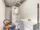 Unfinished basement bathroom with a sink, toilet, medicine cabinet, and white walls at 2237 Avenue B Nw, Winter Haven, FL 33880