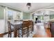 Inviting dining room with hardwood floors, a stylish chandelier, and ample natural light at 2237 Avenue B Nw, Winter Haven, FL 33880