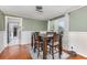 Well-lit dining room features a wooden table with seating for six, adjacent to the cozy living space at 2237 Avenue B Nw, Winter Haven, FL 33880