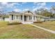 Inviting home with a classic design, showcasing a tidy front yard and a welcoming covered porch at 2237 Avenue B Nw, Winter Haven, FL 33880