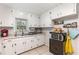 Efficient kitchen with white cabinets, ample counter space, and modern appliances, ideal for cooking enthusiasts at 2237 Avenue B Nw, Winter Haven, FL 33880