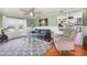 Bright and airy living room featuring hardwood floors, ample seating, and a cozy atmosphere at 2237 Avenue B Nw, Winter Haven, FL 33880