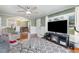 Cozy living room with a fireplace, comfortable seating, and hardwood floors under a ceiling fan at 2237 Avenue B Nw, Winter Haven, FL 33880